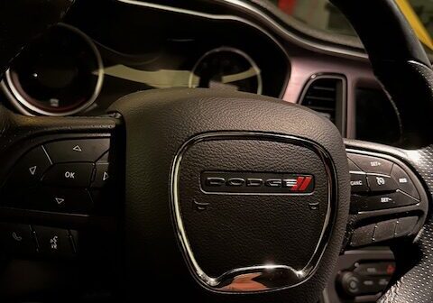 IMG_4551 A car steering wheel with the dashboard turned on.