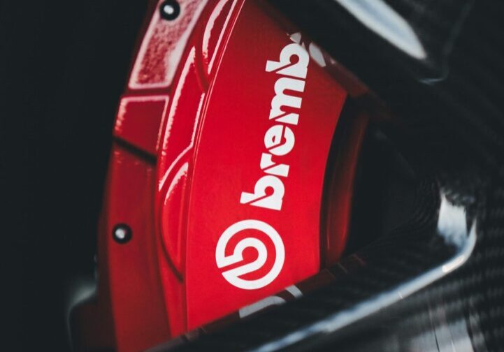 brake pad A red brake caliper with the word brembo on it.